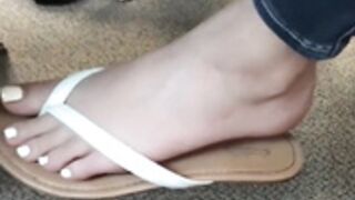 Arabic teen dangling flip flops in class