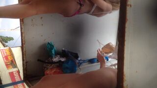 Teens pissing on eachother in a dressing booth on beach